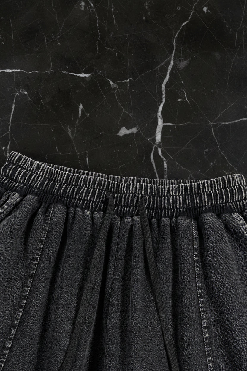 Close-up of a black denim skirt with an elastic waistband on a white background