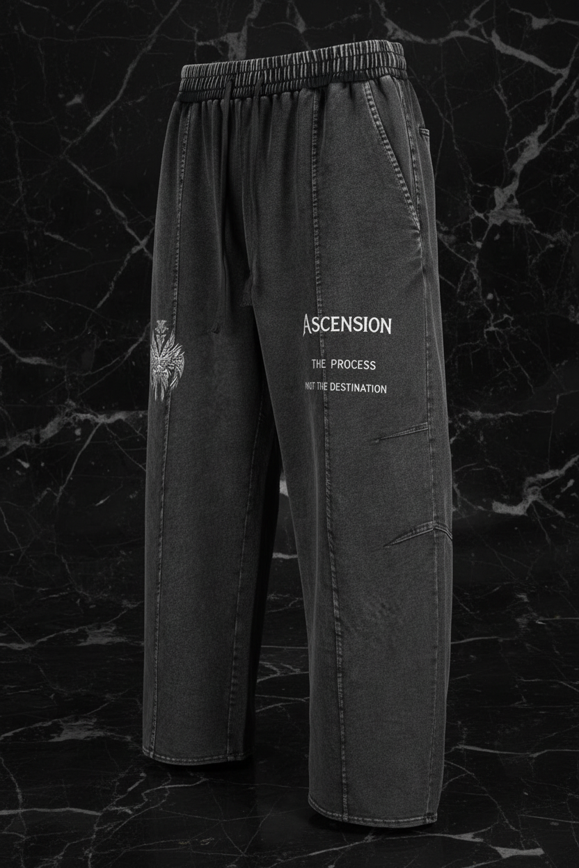 Dark gray pants with text on a black marble background